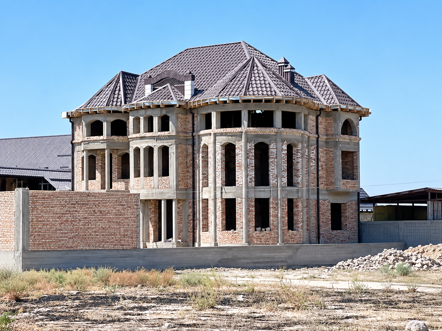 Acoperiș în curs de montaj pe o casă din cărămidă.